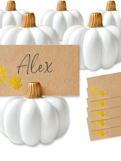This set of white pumpkin place card holders comes with kraft paper cards, ready for you to personalize. They provide a chic and festive way to assign seating for events like Thanksgiving or a harvest-themed dinner.