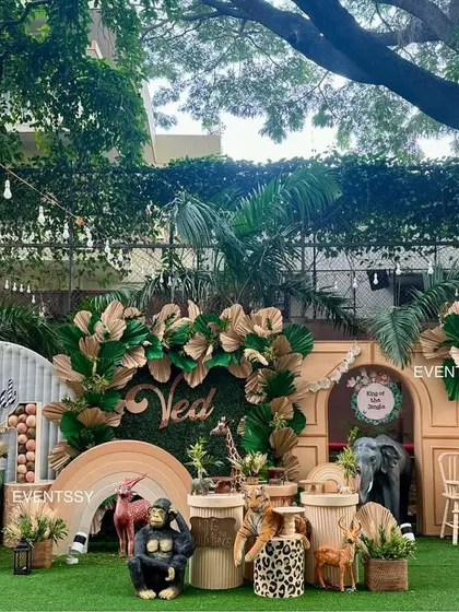 I created a boho-chic 'Wild One' jungle theme using a palette of earthy tones, dried palm leaves, and large animal props for a stylish and immersive first birthday celebration.