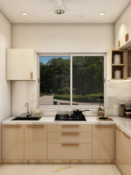 This L-shaped kitchen design features warm beige cabinets, a large window for natural light, and a clean, functional layout perfect for everyday cooking.