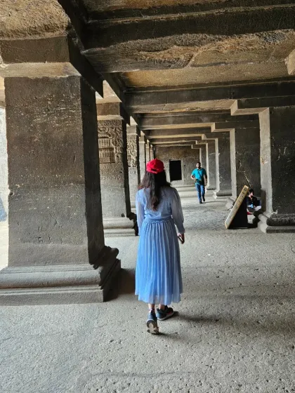 Walking through the massive stone pillars inside one of the Ellora caves. The play of light and shadow in these ancient halls is something I often try to capture in my art.