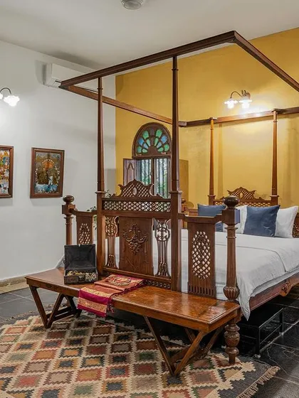 A look inside our luxurious Arundati suite, featuring a classic four-poster bed and antique furnishings. We offer heritage accommodation to ensure your comfort matches the elegance of your celebration.