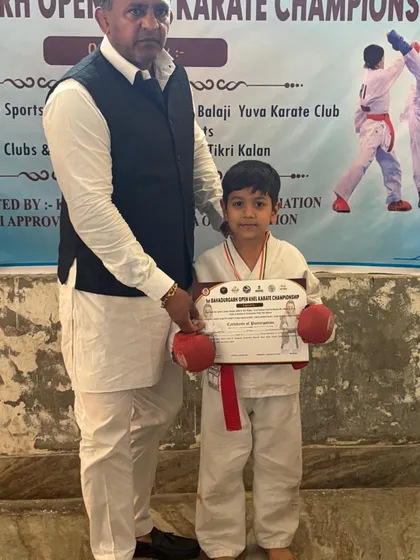 A young student receiving his certificate and medal. We recognize and reward effort at every level.