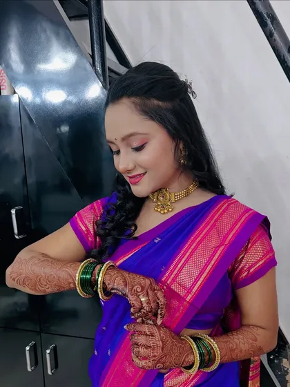 A candid moment showing the client adjusting her green bangles, which add a lovely pop of colour to her look.