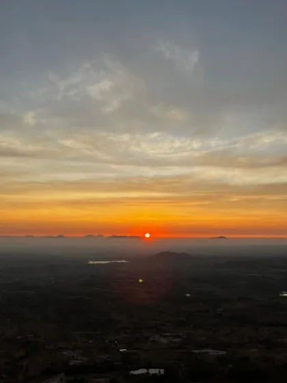 A stunning, wide view of the sunrise, with the orange and yellow sky stretching across the horizon.