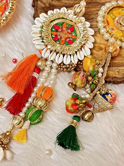 A close-up of my traditional Gota Patti and shell-work Lumba rakhis. The vibrant colors, tassels, and intricate details make them perfect for festive celebrations.