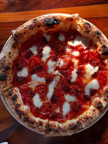 A full view of the Nduja & Sopressata pizza, with its perfectly charred crust.