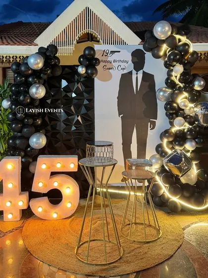 The full setup for the "Supercop" 45th birthday, combining the custom banner, marquee numbers, and balloon decor.