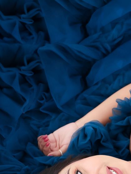 A collection of artistic shots featuring a gorgeous royal blue gown, from full-length portraits to creative close-ups on the fabric and bump.