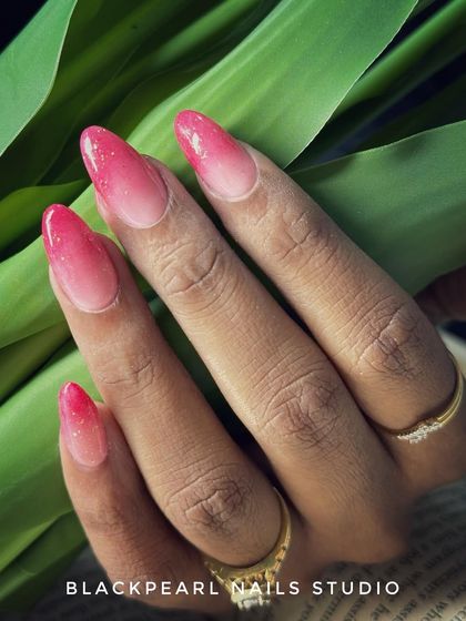 A dreamy ombré blend of nude and coral red, topped with a shimmer coat for extra sparkle. This design is perfect for clients who love a warm, vibrant gradient with a touch of glam.