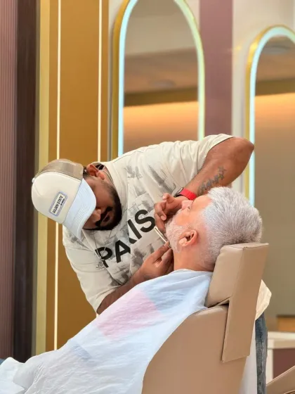 This close-up shows the concentration and skill involved in our beard shaping service. We take pride in delivering flawless results for every client.