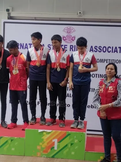 The result of dedication and expert coaching. Our students are seen here on the podium at the Karnataka State Rifle Association Competition in 2024, a testament to the effectiveness of our training programs.
