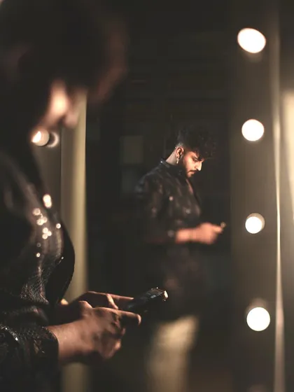 A behind-the-scenes shot. The subtle shimmer of the jacket catches the light, adding a touch of celebratory sparkle to the look.