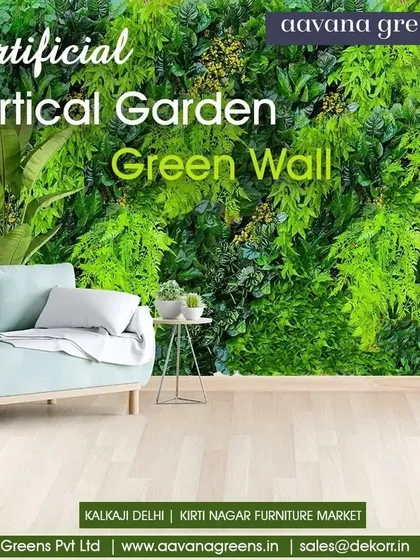 A full green wall brings a breath of fresh design into this modern living space. It acts as a stunning feature wall behind the sofa, creating a calm and natural atmosphere.