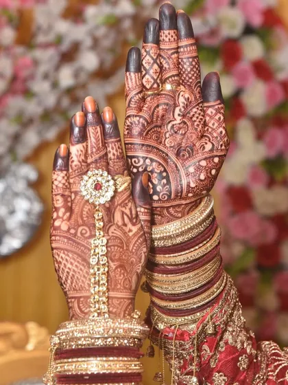 The final look, Masha'Allah. Seeing the deep henna stain adorned with bridal bangles and jewellery is a blessing. This is the moment your bridal look comes together, rich in tradition and beauty.
