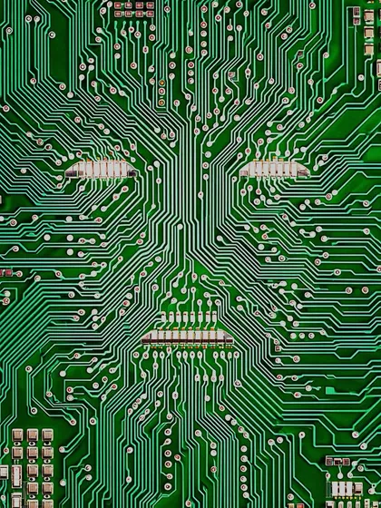 A face emerges from the intricate pathways of a green circuit board. A simple, early exploration of the 'ghost in the machine' concept.