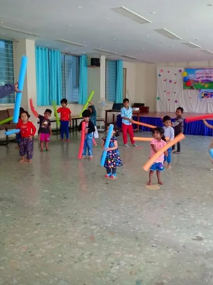An energetic aerobics session using colorful pool noodles as props. Incorporating fun equipment like this keeps kids engaged while they improve their cardiovascular fitness and coordination.