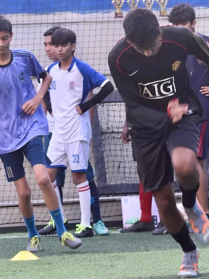 Young players performing agility and footwork drills during a football training session. These exercises are fundamental for developing the quickness and coordination needed on the field.