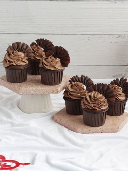 A closer look at our rich chocolate cupcakes with elegant chocolate fan decorations, a decadent treat for your loved one.