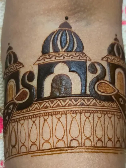 A bridal startup design featuring a palace dome and peacock motifs. This is a great example of how to begin a complex bridal piece on the arm.