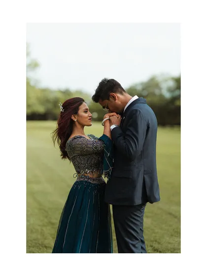A gesture of chivalry and love. This beautifully composed shot of Aman kissing Fazilah's hand has the feel of a classic romance, set against the simple backdrop of a green field.
