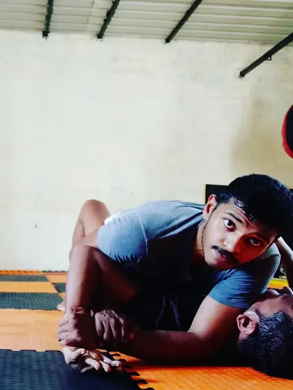 A close-up shot during a No-Gi sparring session. I'm working to secure a kimura grip from top side control, a high percentage submission lock.