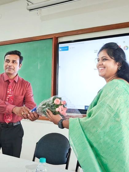 Receiving a bouquet from Prof. Dr. Natarajan Kumaresapillai at T.John College of Pharmacy. His efforts made the entire program a great success.