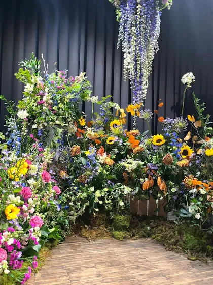 I created this "Glorious Colorful Meadow" as a floral set for a photo shoot. The design mimics a wild field with sunflowers, delphiniums, and a mix of colorful blooms, providing a vibrant and natural background.