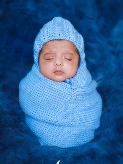 A collage showing two brothers, with the younger one dressed in a blue wrap to match his older brother's first newborn photo. A sweet family tradition!