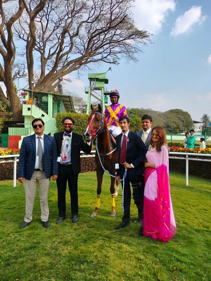 La Reina, with jockey Antony Raj S., poses with the winning team after a great victory.