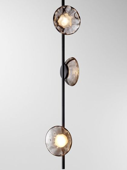 A vertical Ceto configuration, with three glass shades mounted on a single black stem, perfect for narrower spaces or corners.