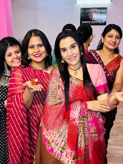 Holding diyas and spreading the light of Diwali. The studio's ambiance is perfect for festive photoshoots.