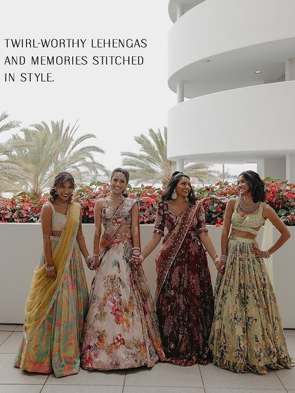 Twirl-worthy lehengas and memories stitched in style. This shot showcases the bride with her bridesmaids, each in a unique silhouette and print that complements the others. We believe in styling the bride tribe to be a beautiful extension of the bride's look, creating a picture of friendship and celebration.