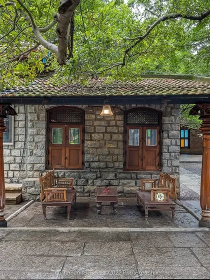 This stone structure, nestled under a sprawling tree, is one of the many corners filled with old-world charm, perfect for intimate seating or a quiet photo opportunity.