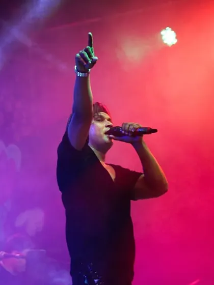 Pointing to the sky, lost in the music. Festival performances are all about creating those larger-than-life moments.