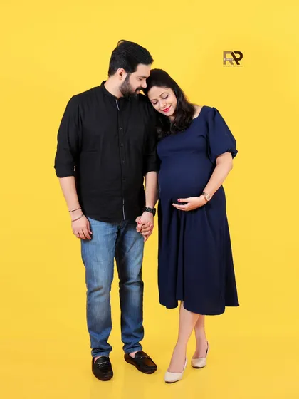 Joyful, bright, and full of anticipation. This classic couple portrait against a vibrant yellow backdrop is perfect for capturing the happy energy of waiting for your little one. Our studio is equipped with a variety of colorful backdrops to match your style.