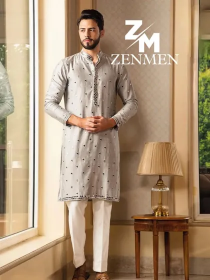 A model wearing a grey kurta with a subtle, scattered pattern and mirror work accents on the collar. An understated yet elegant choice for any celebration.