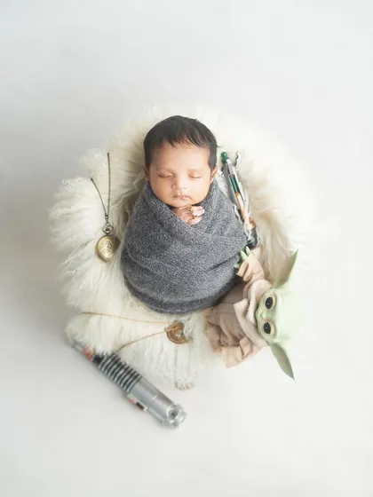 The force is strong with this little one. For the Star Wars fans, I created this adorable setup with a baby Yoda and a lightsaber, proving that even the tiniest Jedi can be powerful.