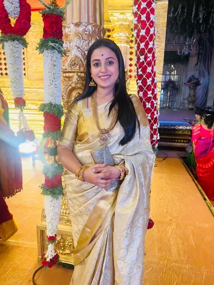 Our gorgeous client Soundarya looks divine in this white and golden designer silk saree, a masterpiece perfect for grand celebrations.