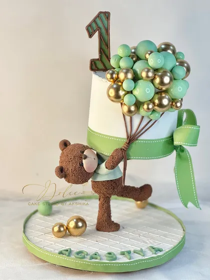 This is "Gullu ka chota bhai," a gravity-defying cake where the teddy bear holds a bunch of edible balloons. It’s a playful take on the floating cake concept.