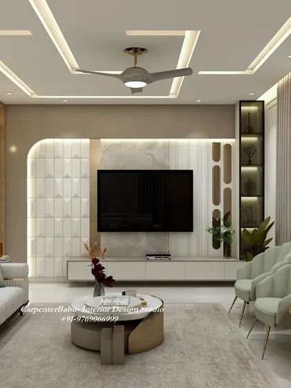 The TV unit in this room is framed by an arched niche and features a mix of 3D panels and a marble-finish back. The design is both modern and artistic.