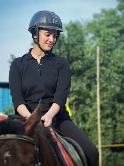 A classic equestrian portrait focusing on the rider. The greenery and open sky in the background provide a clean and natural setting for your photos.