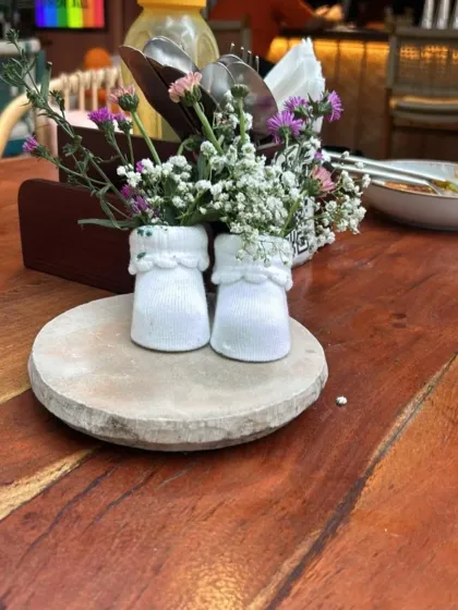Another look at the creative baby sock floral centerpiece, a charming detail for any baby shower table.