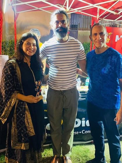 Posing with some of the vendors at an outdoor mela. It takes a village to put on a great event.