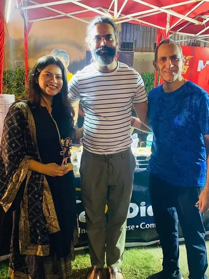 Posing with some of the vendors at an outdoor mela. It takes a village to put on a great event.
