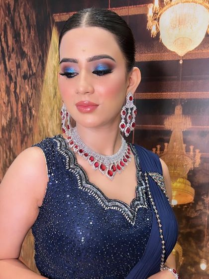 A stunning engagement look featuring a bold blue smokey eye. The vibrant color on the eyes is balanced with a soft nude lip, letting the eyes be the star of the show.