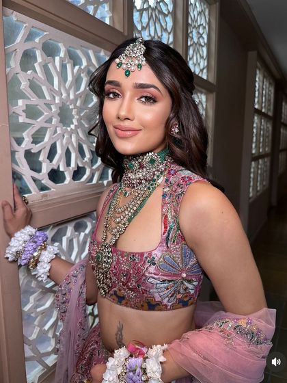 A close-up of the model, her soft hairstyle and makeup creating a fresh and youthful look.