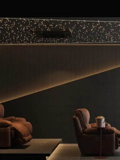 A duplicate of image 28, this view highlights the ambient lighting along the floor and wall, which guides the way without creating glare on the screen, enhancing the movie-watching experience.
