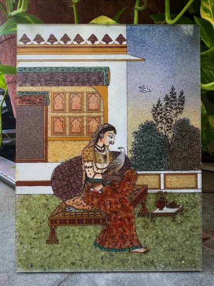 This painting of Bani Thani is a tribute to the timeless elegance of Rajasthani royalty. Inspired by the famous Kishangarh school of art, I use finely crushed gemstones to capture the grace and intricate details of her attire and the royal haveli setting. It is a piece of our heritage, designed to bring a sense of history and refinement to your space.