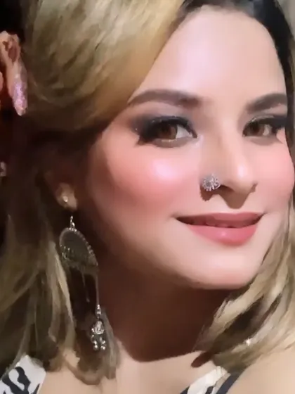 A full-face view of the cocktail look, complete with a stylish nose pin and statement earrings.