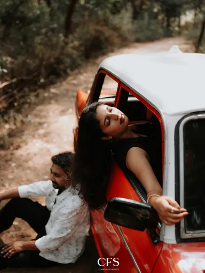 A shot that blends romance with a cool, vintage aesthetic. Using a classic car as a prop adds a unique narrative element, perfect for couples looking for a concept shoot with a touch of old-school charm.
